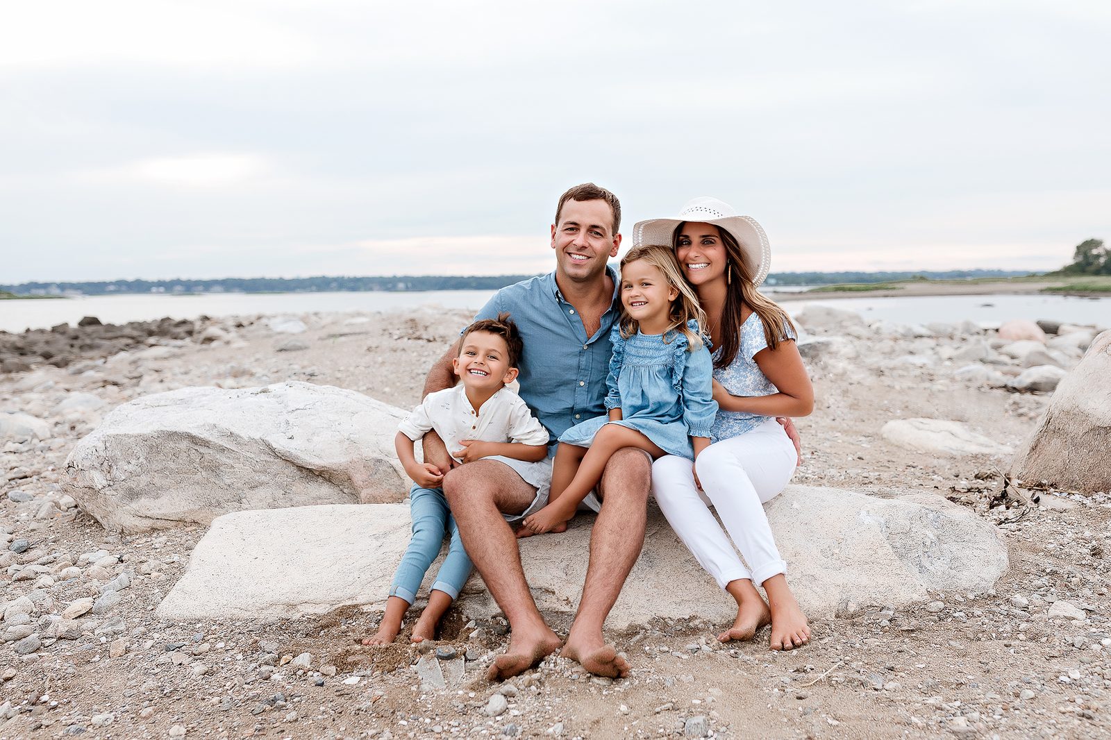 A family portrait on the rocks at Walnut Beach on the Long Island Sound